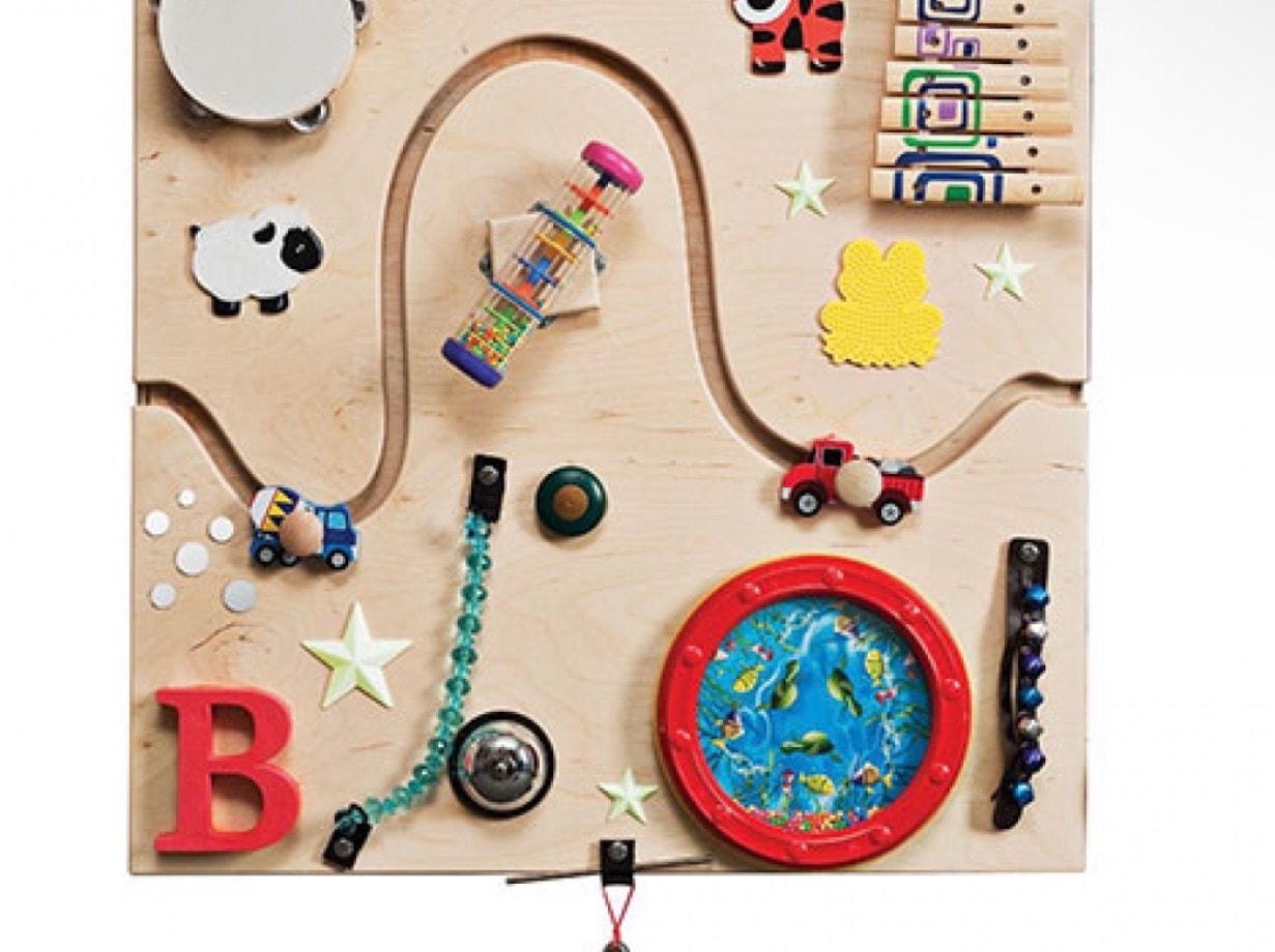 Interactive sensory play board with musical instruments and tactile elements